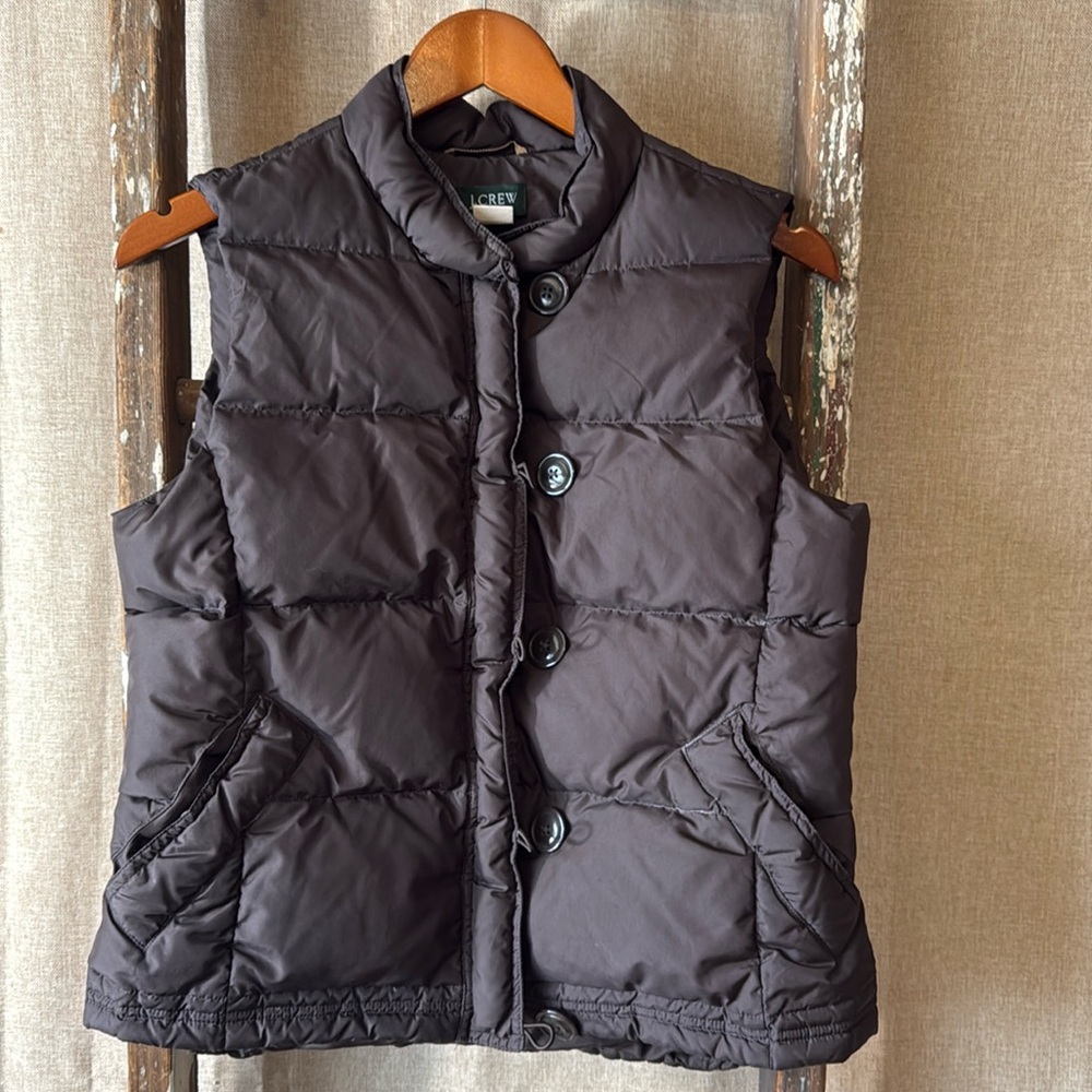 J.Crew goose down and water foul 
feather and some polyester fill vest.